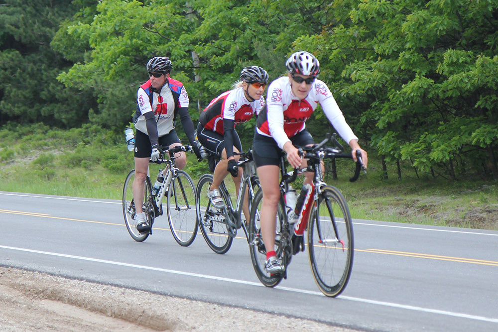 Three cyclists completing a cycling training session