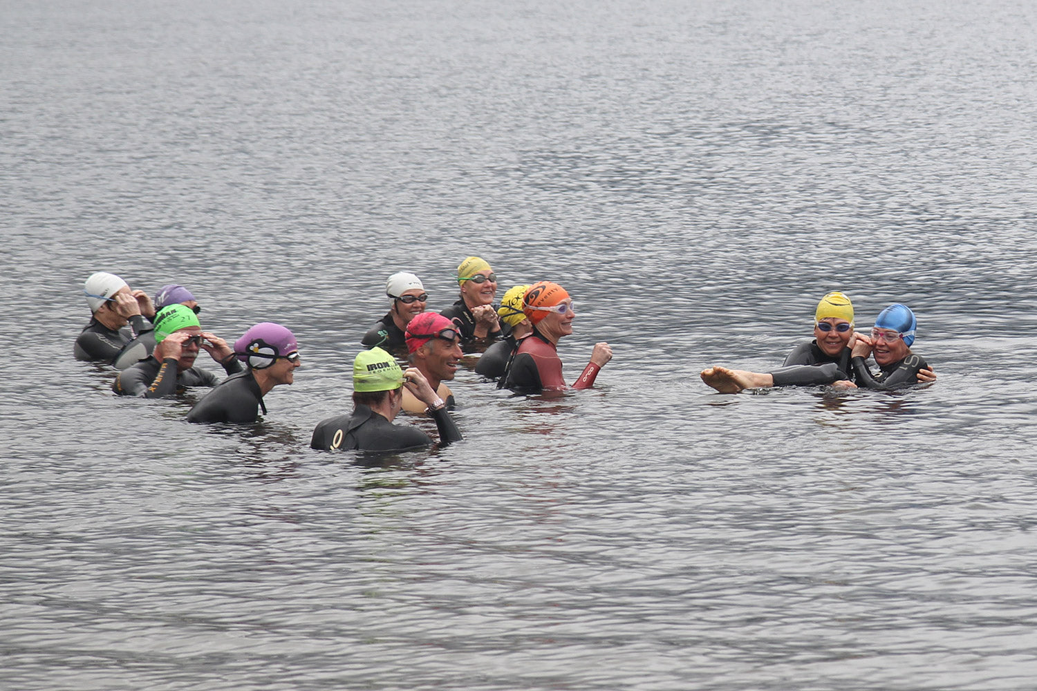 Group of athletes completing an open water training camp swim session